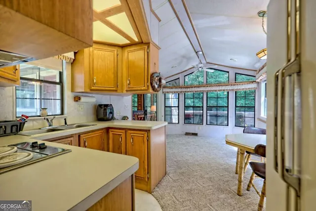 a view of a porch with furniture and a yard