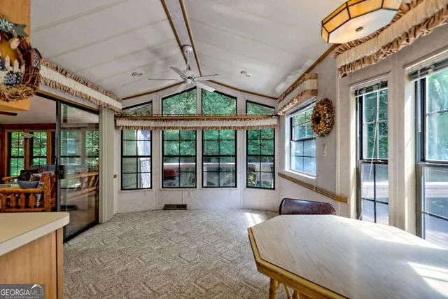 a dining room with furniture window and outside view