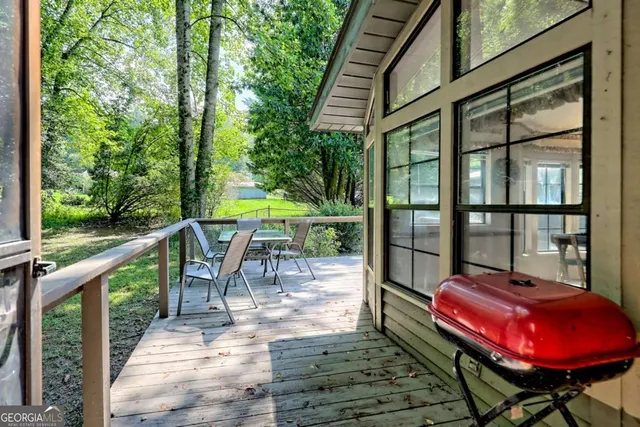 a kitchen with kitchen island granite countertop a sink cabinets and stainless steel appliances