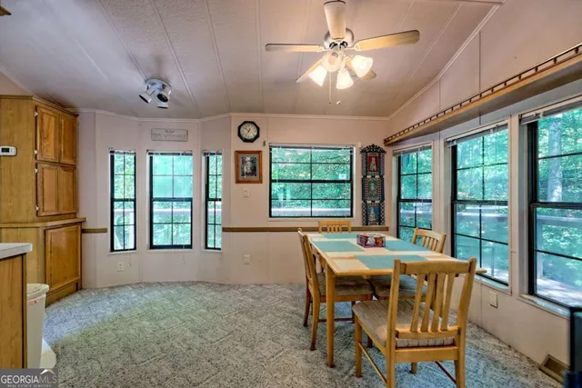 a bedroom with a bed and a large window with outer view