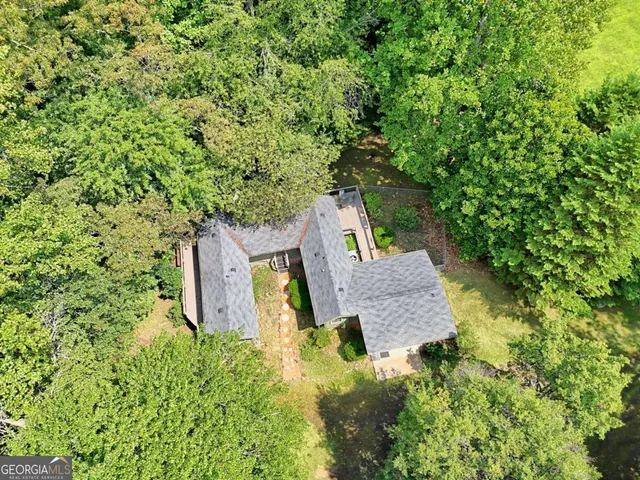 an aerial view of a house with a yard basket ball court and outdoor seating