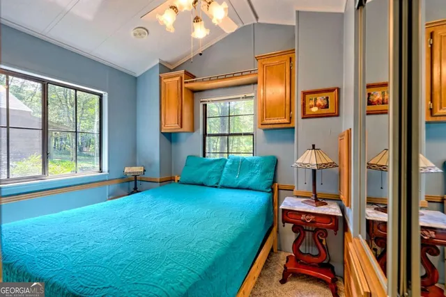 a front view of a house with a garden and trees