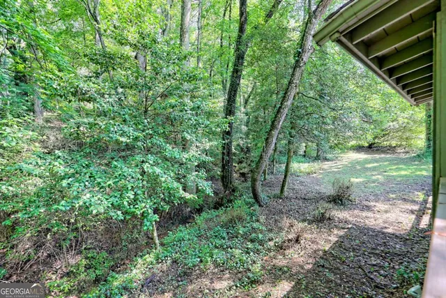an aerial view of a houses with a yard and lake view