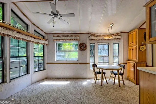 a view of a room with furniture and windows