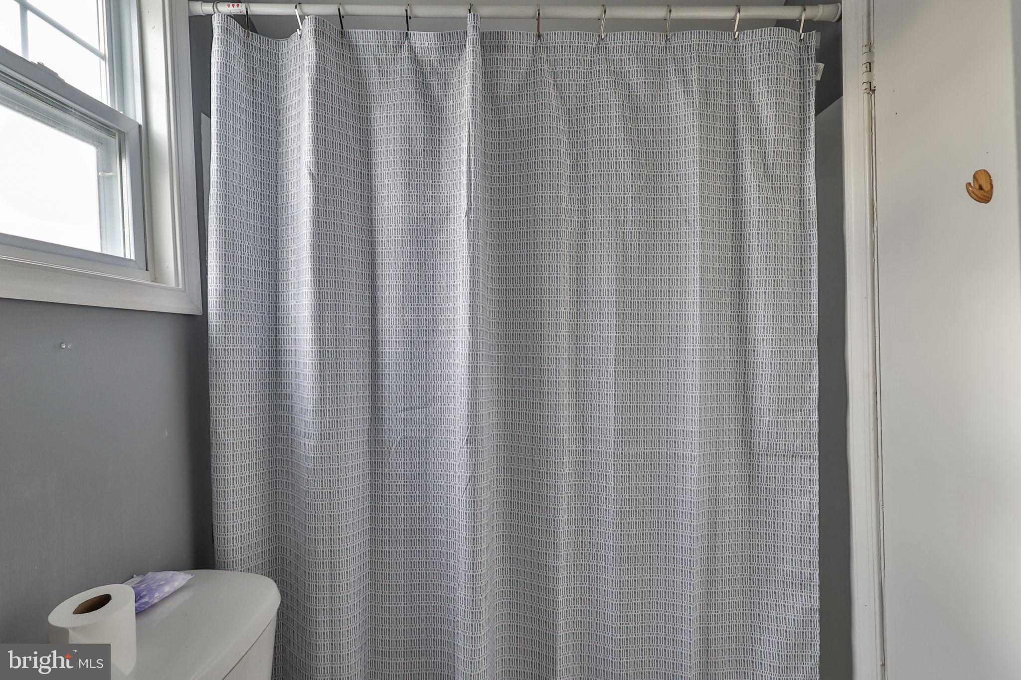 708 Ward Street Chester, PA 19013 - Photo 29 of 44 a bathroom with a shower curtain and sink