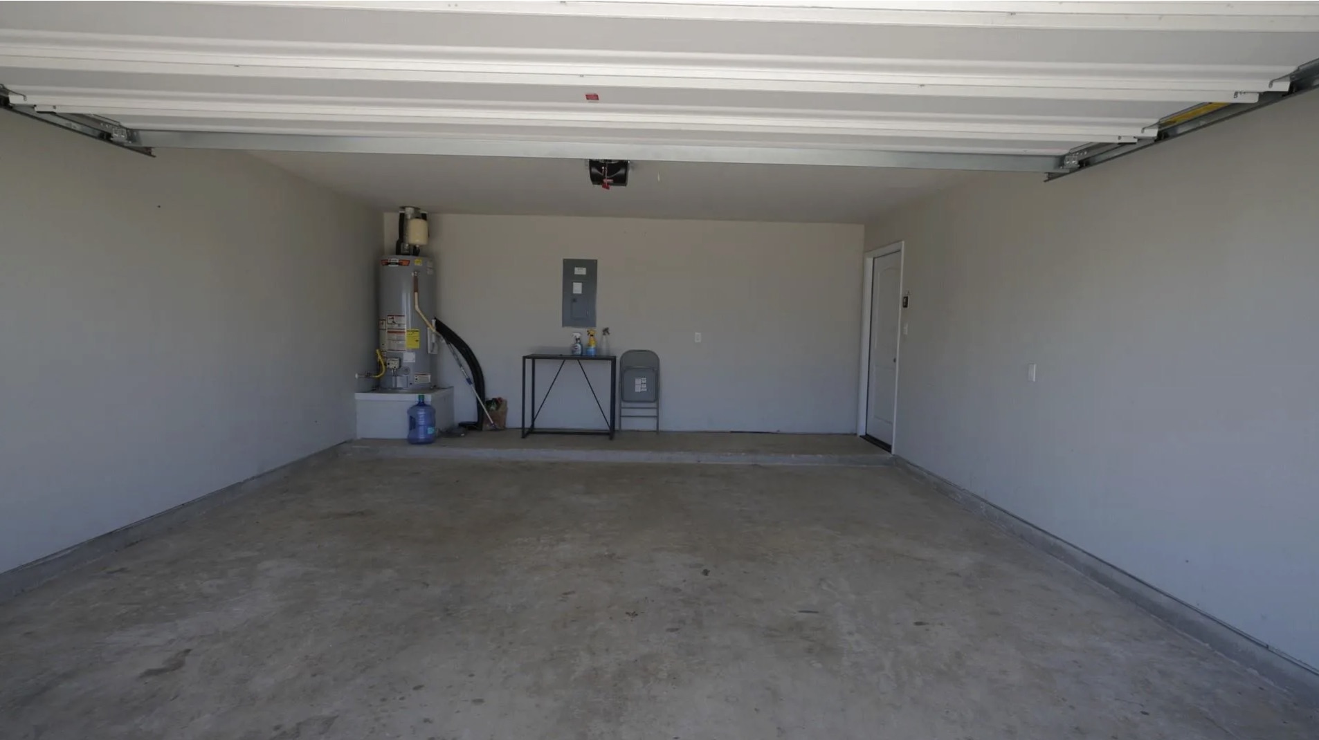 251 Tempest Trail Maxwell, TX 78656 - Photo 11 of 15 Garage featuring water heater and electric panel