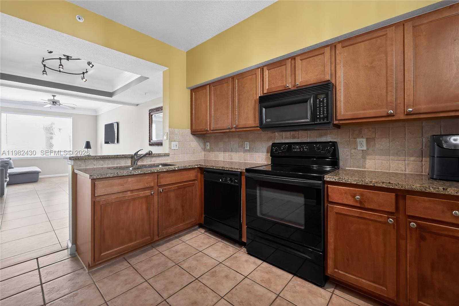 156 Aragon Way, Unit 103 Jupiter, FL 33458 - Photo 11 of 30 a kitchen with stainless steel appliances granite countertop a sink and cabinets