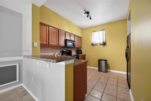 a kitchen with a sink appliances and cabinets