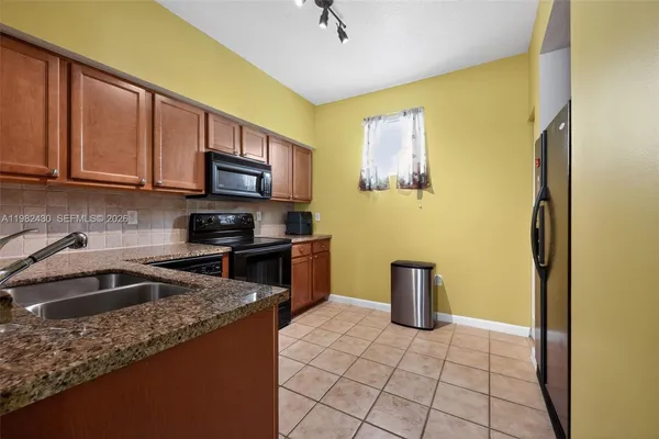 a kitchen with a sink and a stove top oven