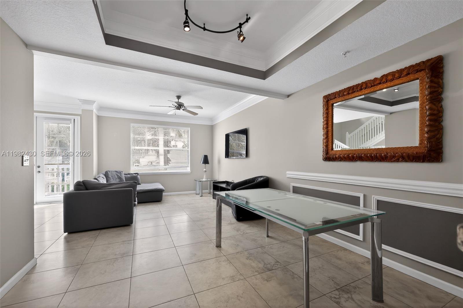 156 Aragon Way, Unit 103 Jupiter, FL 33458 - Photo 14 of 30 a living room with furniture and a window