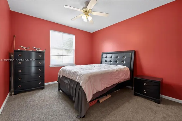 a spacious bedroom with a bed and a window