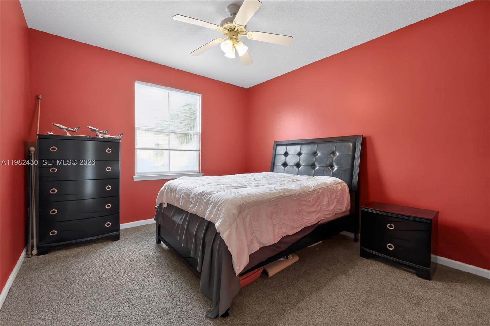 156 Aragon Way, Unit 103 Jupiter, FL 33458 - Photo 18 of 30 a spacious bedroom with a bed and a window