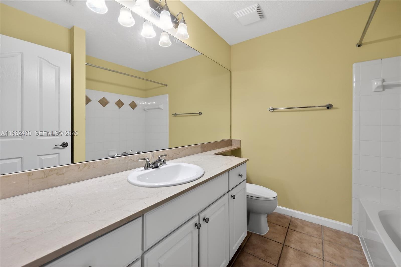 156 Aragon Way, Unit 103 Jupiter, FL 33458 - Photo 19 of 30 a bathroom with a granite countertop sink toilet and shower