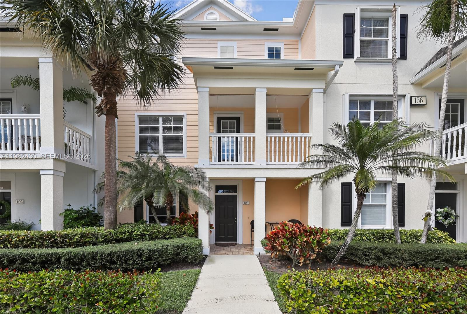 156 Aragon Way, Unit 103 Jupiter, FL 33458 - Photo 2 of 30 a front view of a house with a yard