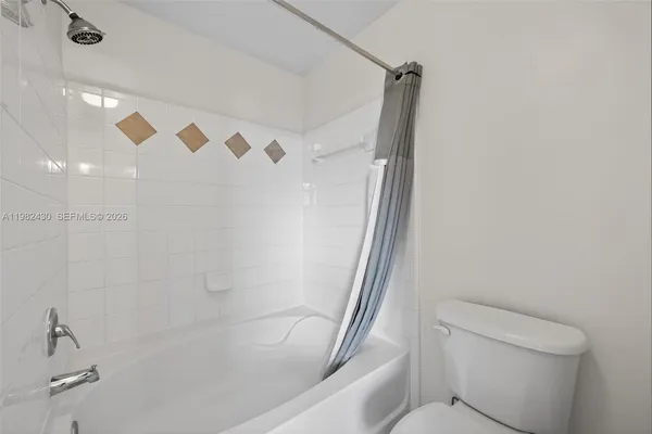 a bathroom with a shower and a toilet