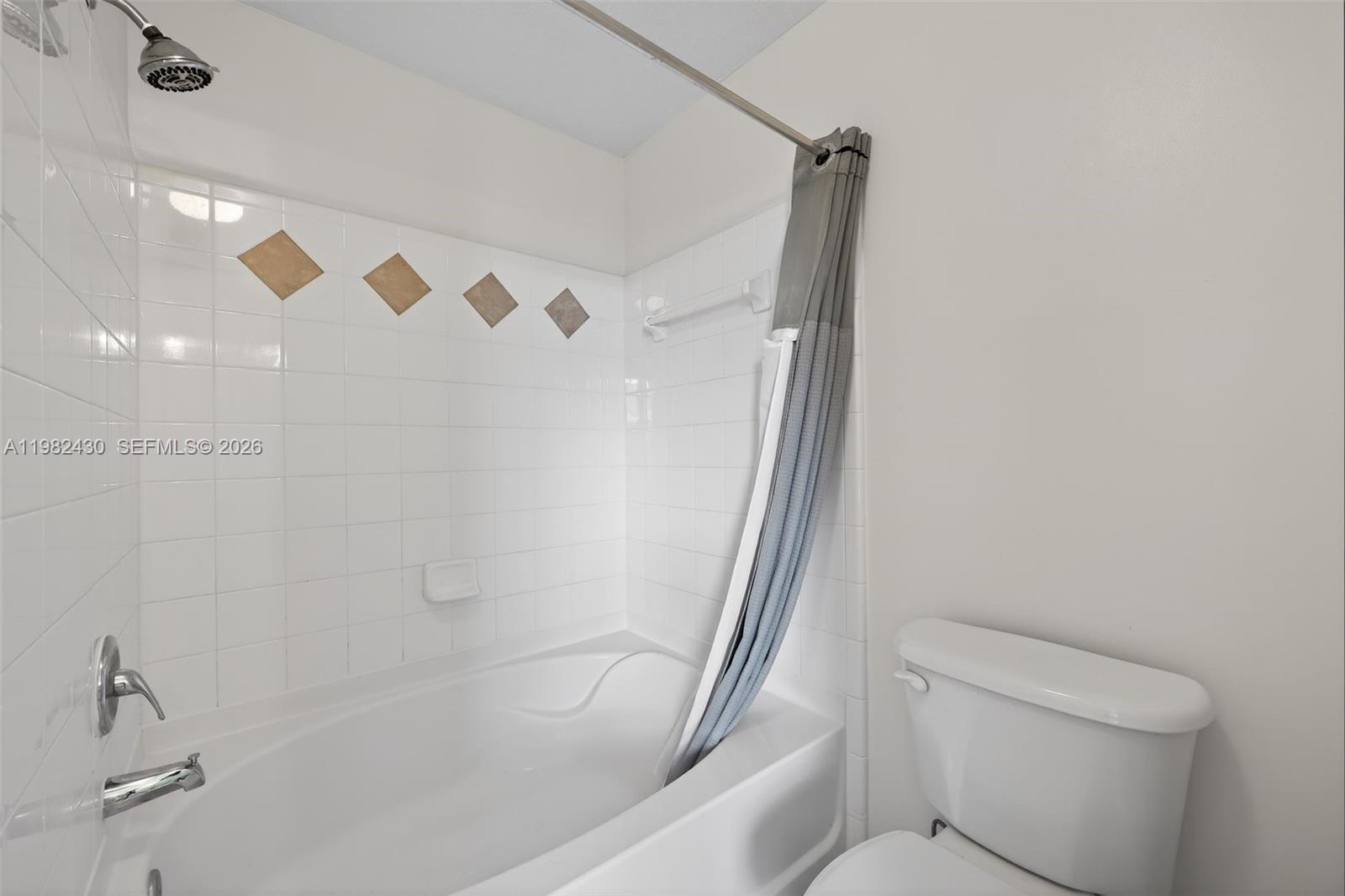 156 Aragon Way, Unit 103 Jupiter, FL 33458 - Photo 22 of 30 a bathroom with a shower and a toilet