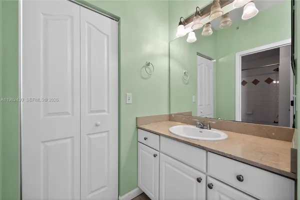 a bathroom with a sink vanity and a mirror