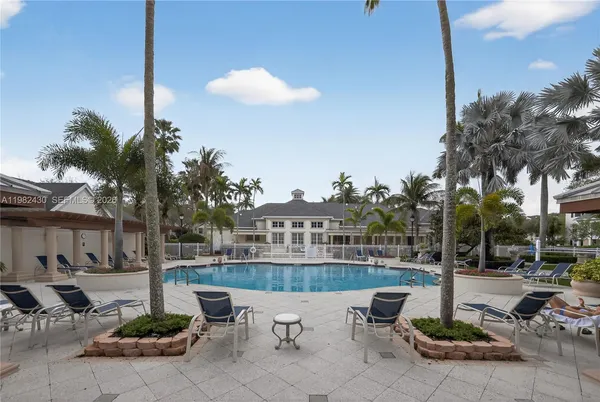 a view of a patio with table and chairs potted plants and palm tree