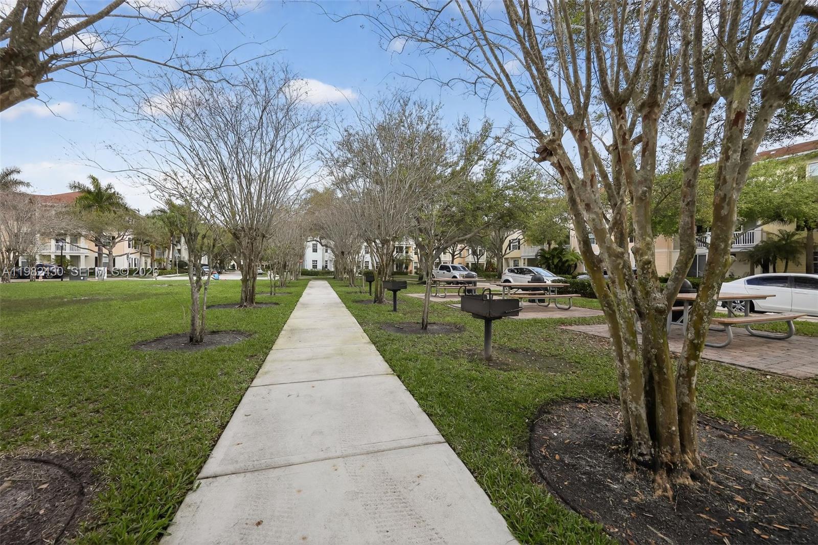 156 Aragon Way, Unit 103 Jupiter, FL 33458 - Photo 30 of 30 a park view with large trees