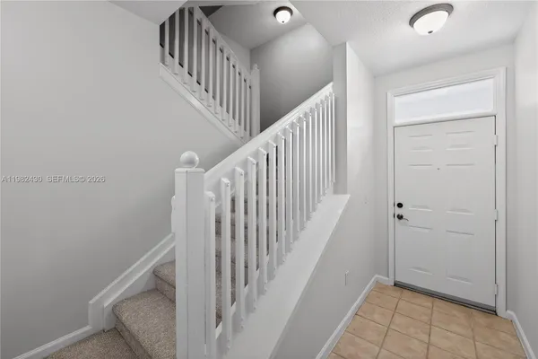 a view of a hallway with wooden floor and entryway