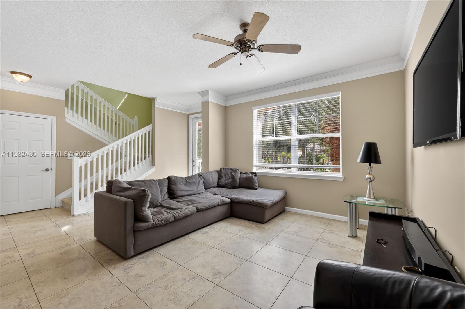 156 Aragon Way, Unit 103 Jupiter, FL 33458 - Photo 7 of 30 a living room with furniture and a flat screen tv