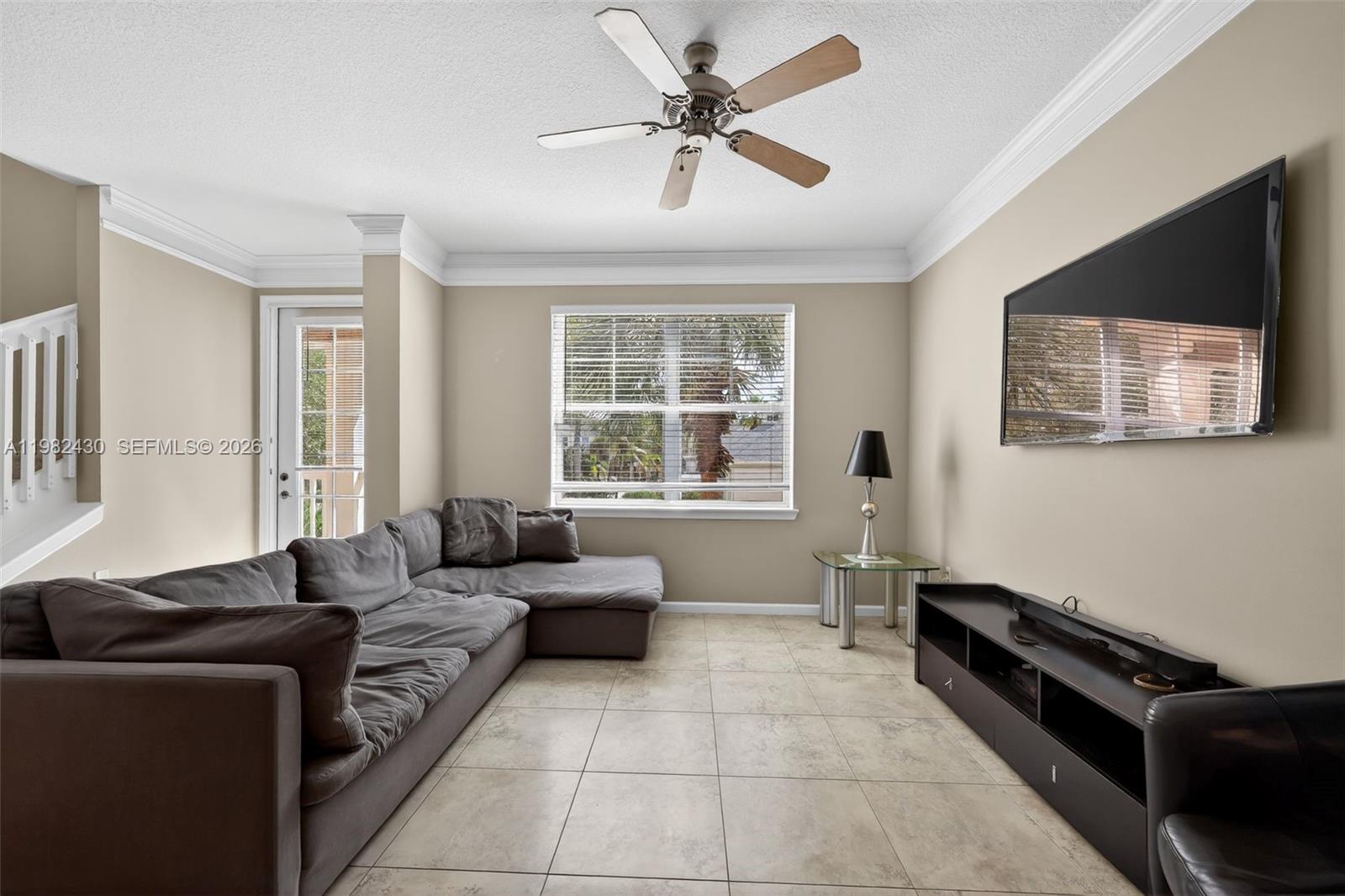 156 Aragon Way, Unit 103 Jupiter, FL 33458 - Photo 9 of 30 a living room with furniture and a flat screen tv