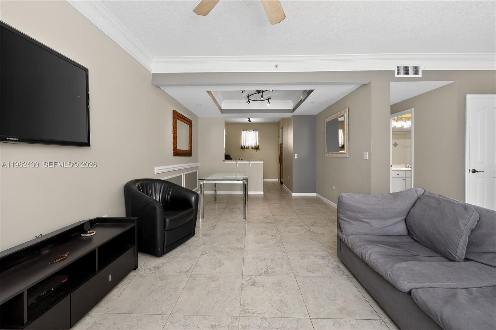 156 Aragon Way, Unit 103 Jupiter, FL 33458 - Photo 10 of 30 a living room with furniture and a flat screen tv