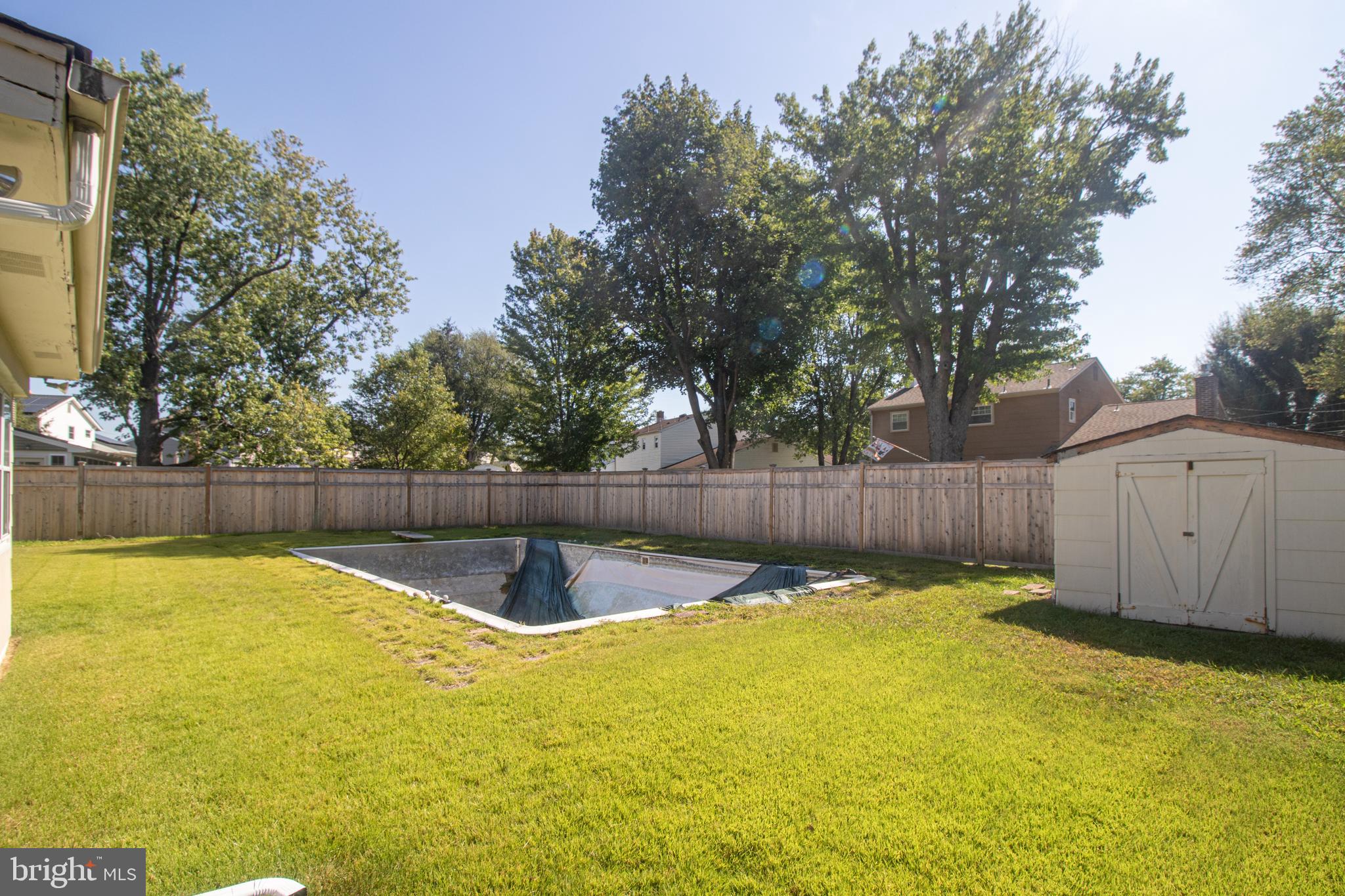 25 Champlain Road Marlton, NJ 08053 - Photo 34 of 35 a swimming pool with a small yard and wooden fence