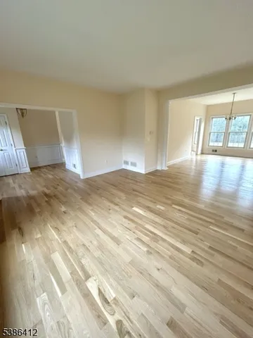 a view of room with window and wooden floor