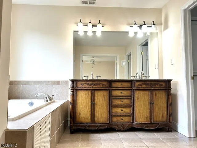 a bathroom with a sink vanity and mirror