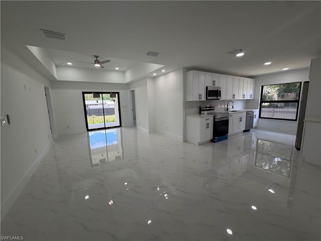 15 Louisiana Road Lehigh Acres, FL 33936 - Photo 7 of 22 a view of a kitchen with a sink refrigerator and windows
