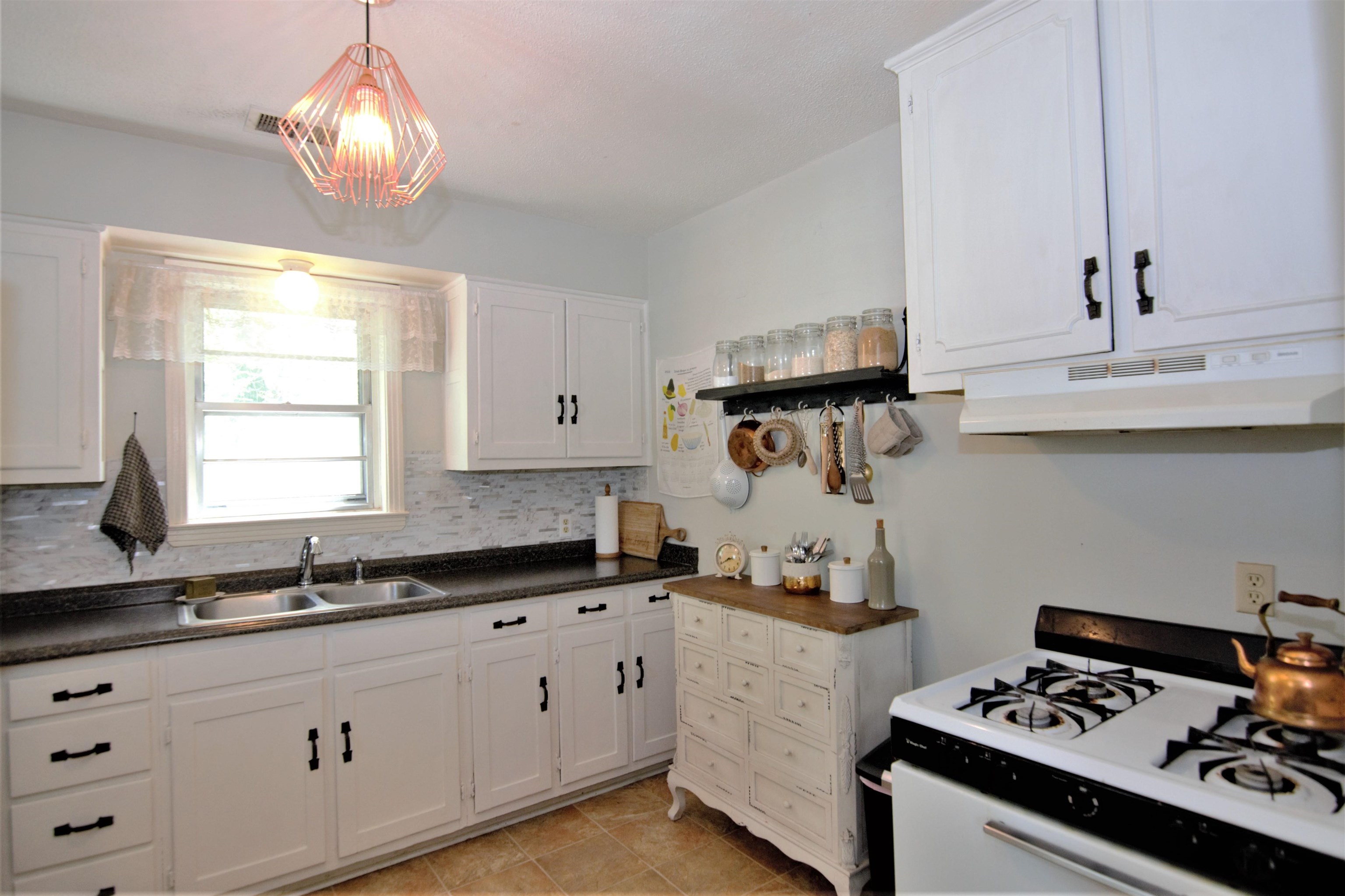 4349 Macon Road Memphis, TN 38122 - Photo 6 of 19 a kitchen with kitchen island granite countertop cabinets a sink and a stove