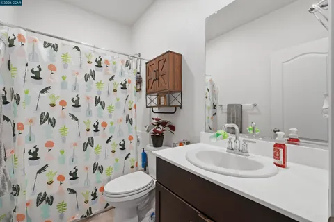 a kitchen with stainless steel appliances kitchen island granite countertop a table chairs sink and cabinets