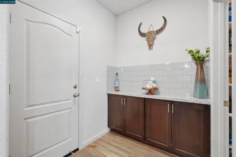 a view of kitchen with furniture and refrigerator