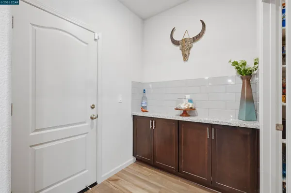 a view of kitchen with furniture and refrigerator