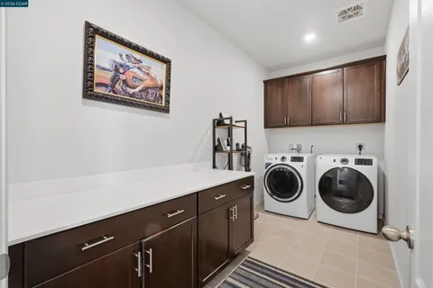 a living room with lots of furniture and a book shelf