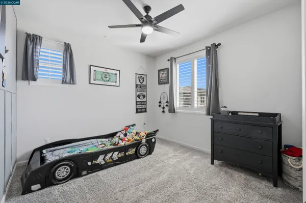 a bedroom with bed and a flat screen tv