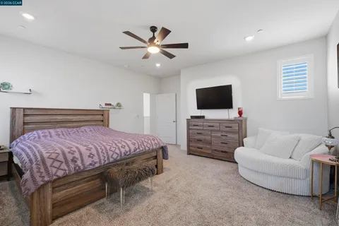 a bathroom with a tub sink vanity granite and shower