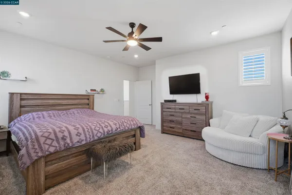 a bathroom with a tub sink vanity granite and shower
