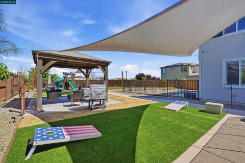 a swimming pool with outdoor seating and yard