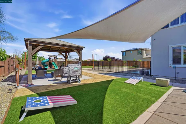 a swimming pool with outdoor seating and yard