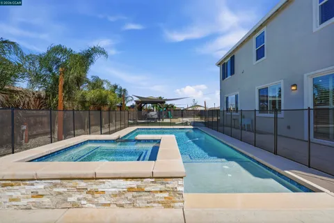 a view of a balcony with two chairs and a table