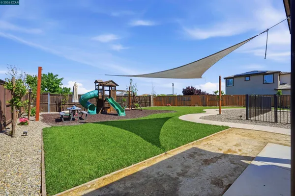 an aerial view of a city with lots of residential buildings ocean and mountain view in back