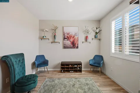 a living room with furniture and view of kitchen