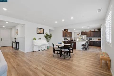 a view of a dining room with furniture and a potted plant