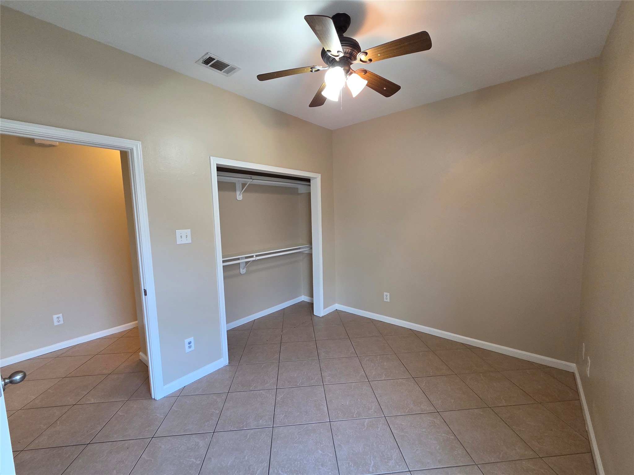 928 Runneburg Road Crosby, TX 77532 - Photo 12 of 26 an empty room with closet and a ceiling fan