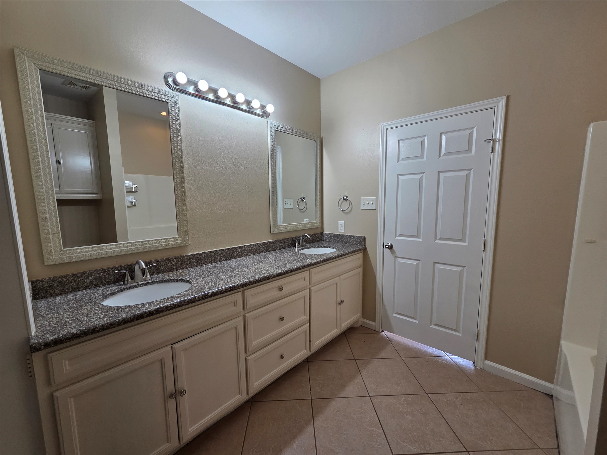 928 Runneburg Road Crosby, TX 77532 - Photo 17 of 26 a spacious bathroom with a granite countertop double vanity sink a mirror and a