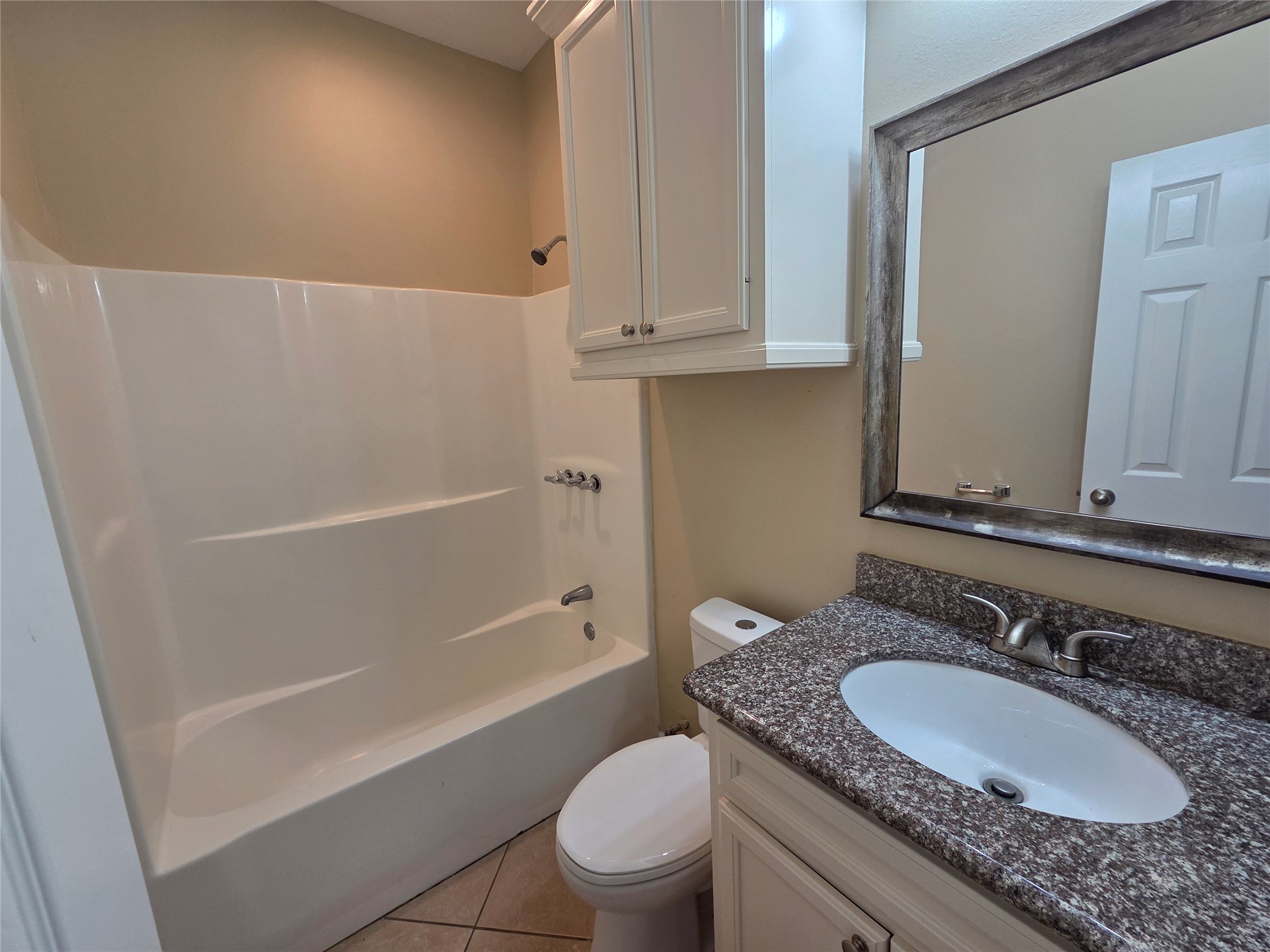 928 Runneburg Road Crosby, TX 77532 - Photo 7 of 26 a bathroom with a granite countertop sink a toilet and a bathtub