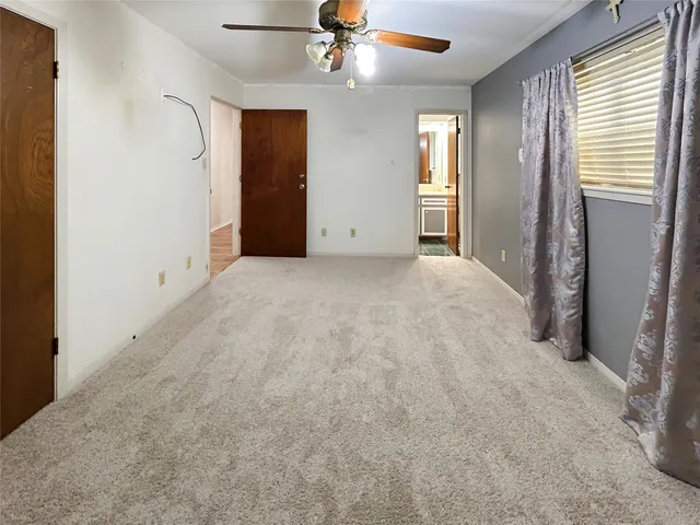 an empty room with windows and closet