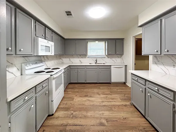 a kitchen with a sink stove and cabinets